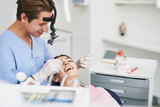 Beautiful girl receiving teeth treatment in dental clinic