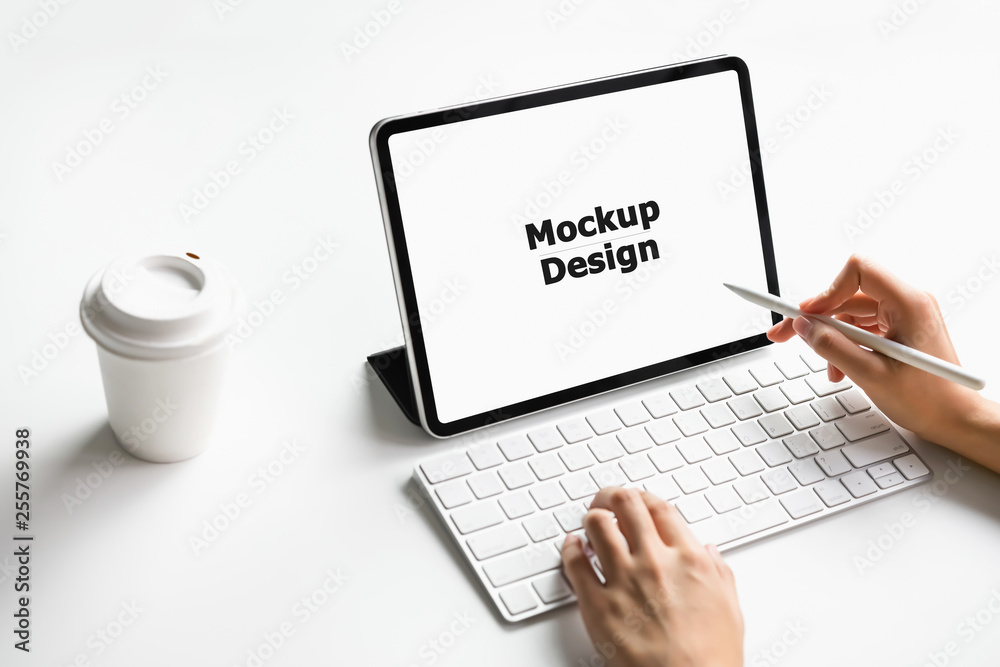 Woman typing keyboard laptop and tablet screen blank on the table mock up to promote your products. Concept of future and trend internet for easy access to information. Woman typing keyboard laptop and tablet screen blank on the table mock up to promote your products. Concept of future and trend internet for easy access to information.