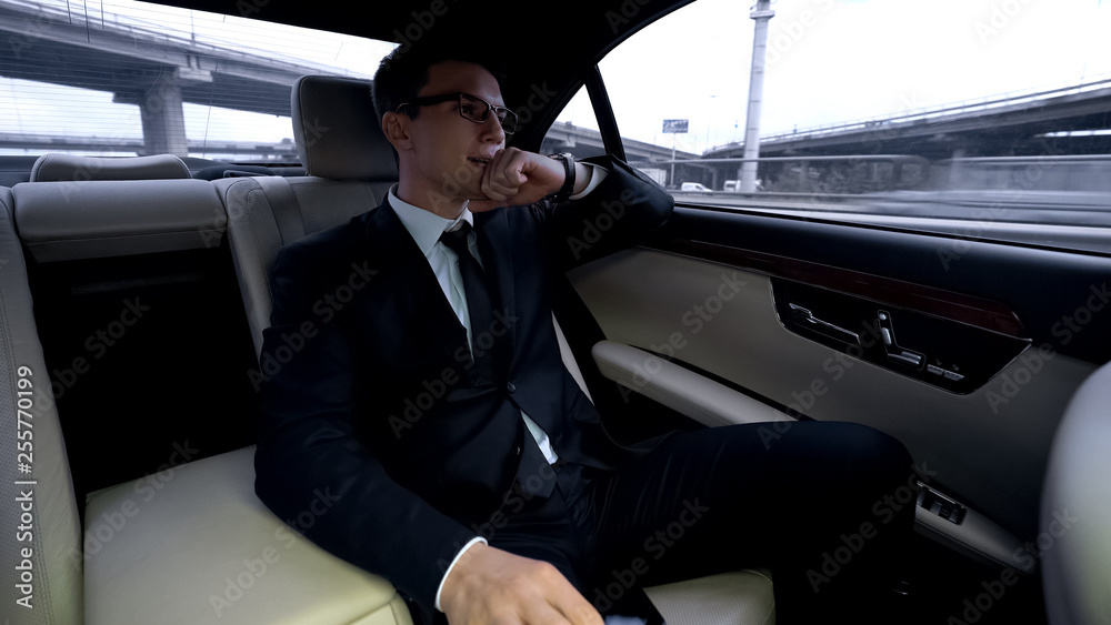 Disappointed man riding in car and looking at big city, failed deal, business