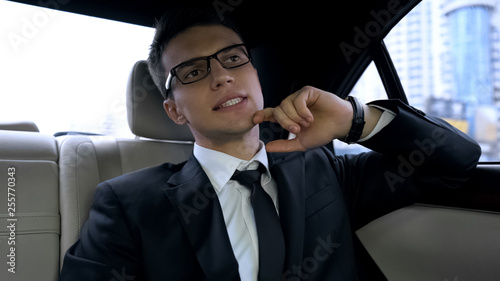 Businessman late for important dinner stuck in traffic jam, megalopolis life © motortion