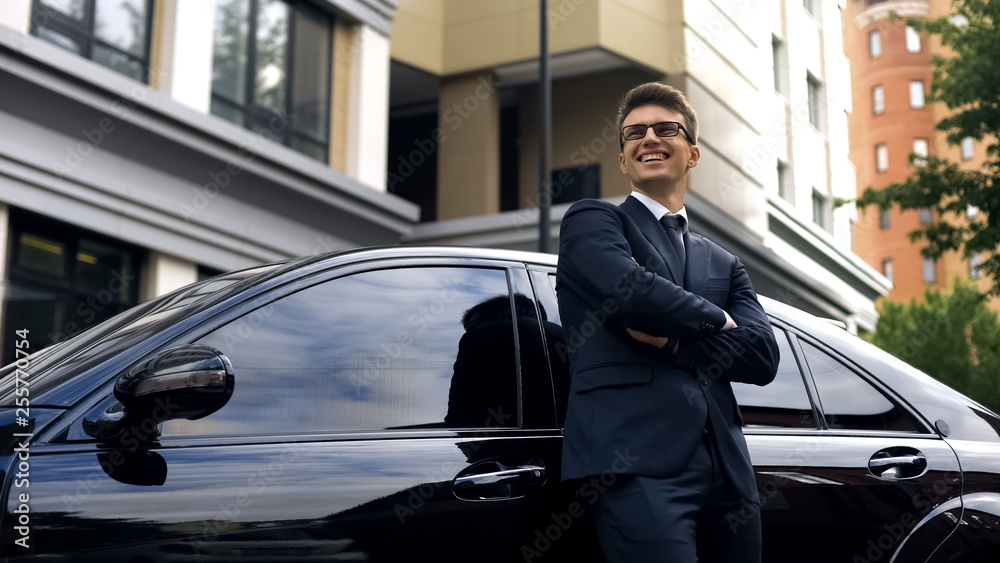 Smiling man standing near premium class car, auto crediting, low interest rate Smiling man standing near premium class car, auto crediting, low interest rate