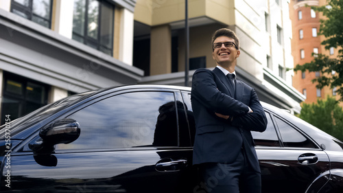 Smiling man standing near premium class car, auto crediting, low interest rate © motortion