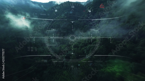 Aerial view from the fighter plane's cockpit flying over the low cloud cover mountain scape with head up display acquire targets and enemies location hidden in the dense mountain forest