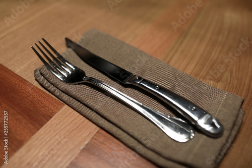 Fork and knife on brown napkin