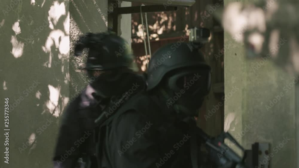 A Special Force Sqaud walk outside through a open door