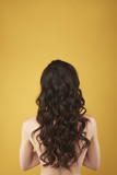 Back side portrait graceful woman with curly hairs