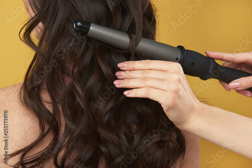 Close up of curler making hairstyle on hairs
