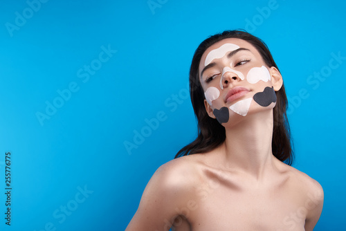 Sensual female with cosmetic lifting face patches