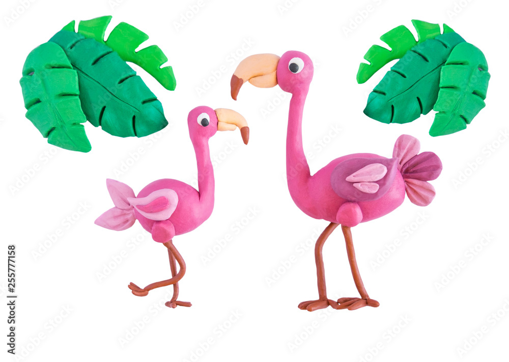 Obraz premium Pink flamingo with palm leaves made of plasticine isolated on white background. Crafts from platinum. Children crafts. Plasticine bird flamingo