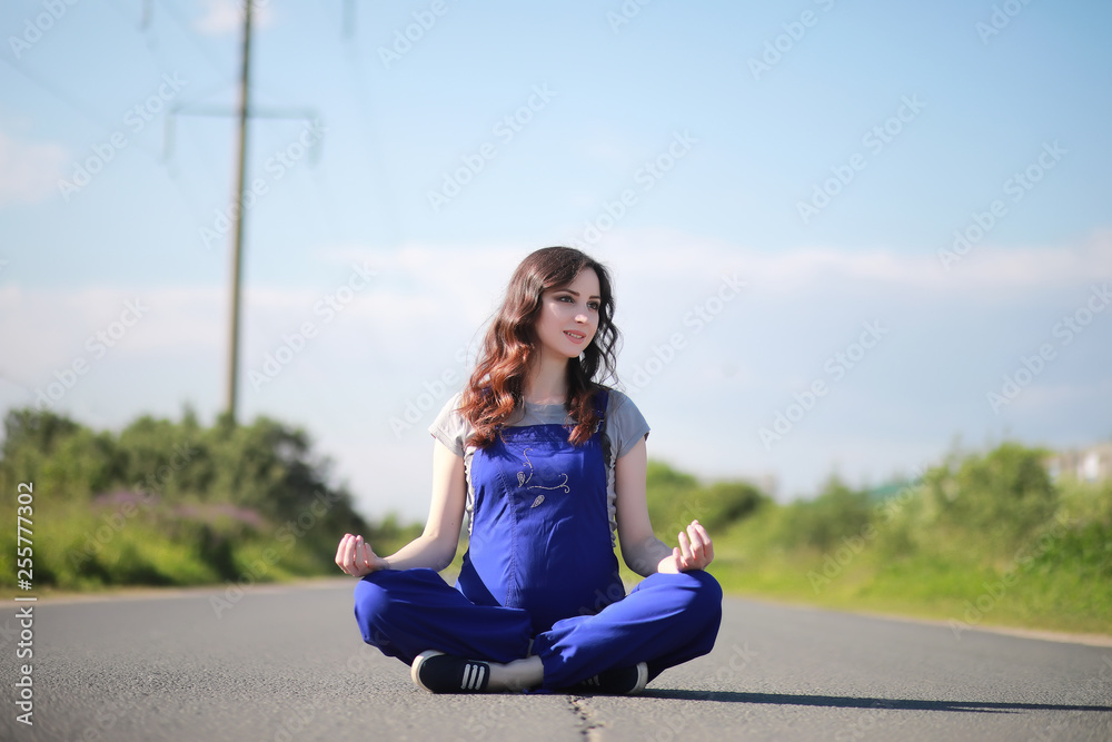 Pregnant woman  on the road yoga