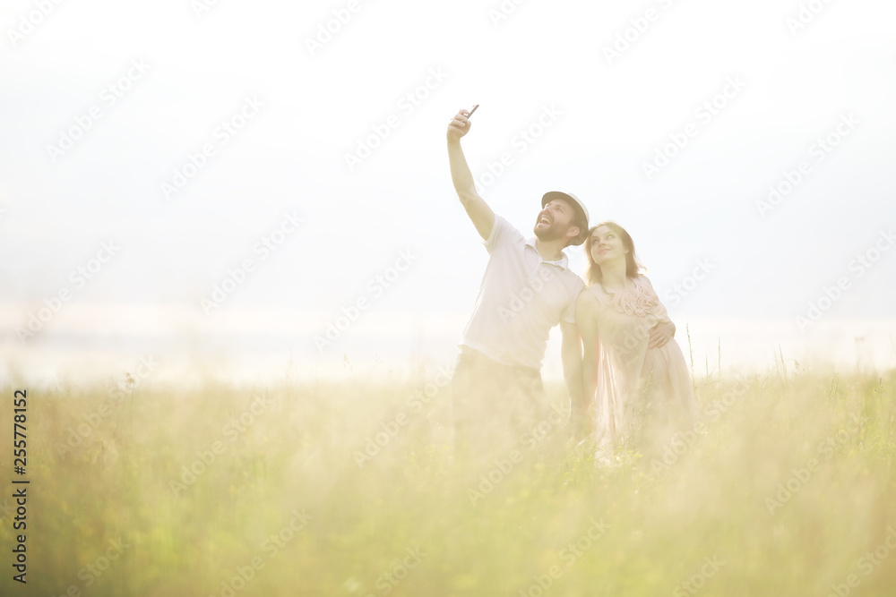 Couple man and pregnant girl in the field