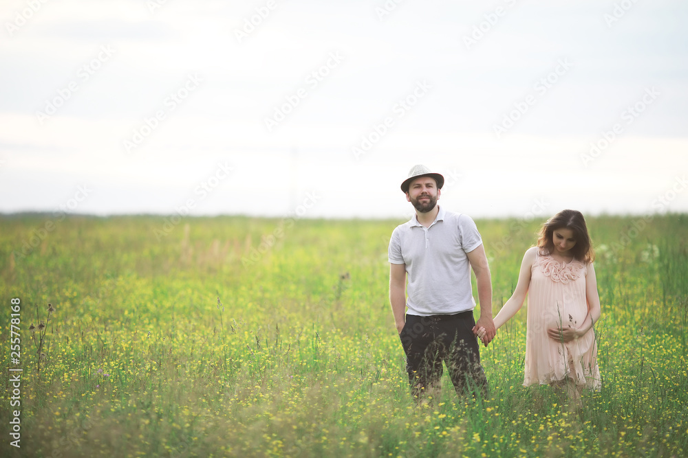Couple man and pregnant girl in the field Couple man and pregnant girl in the field