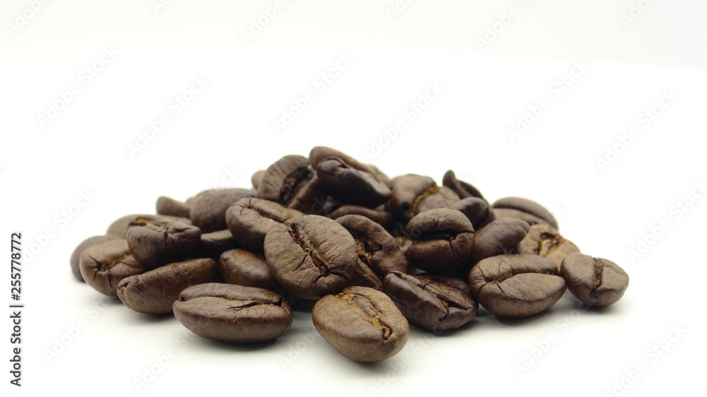 Close up of roasted coffee beans on white background Close up of roasted coffee beans on white background