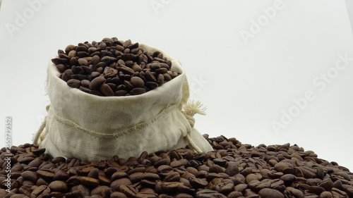 A sack with roasted coffee beans on white background