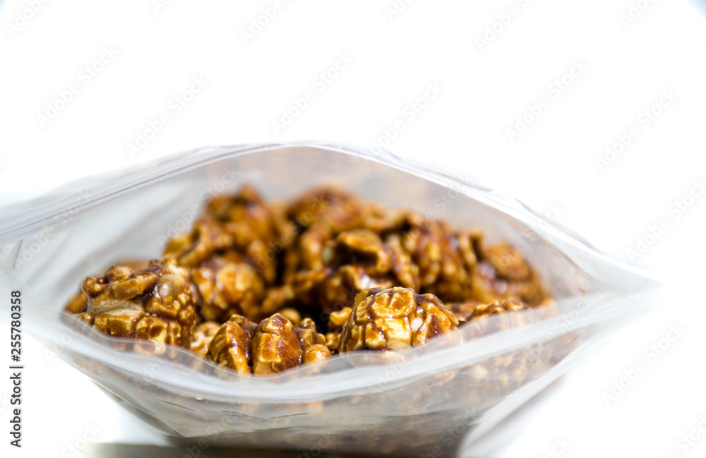 Chocolate covered popcorn in a clear plastic bag. Chocolate covered popcorn in a clear plastic bag.