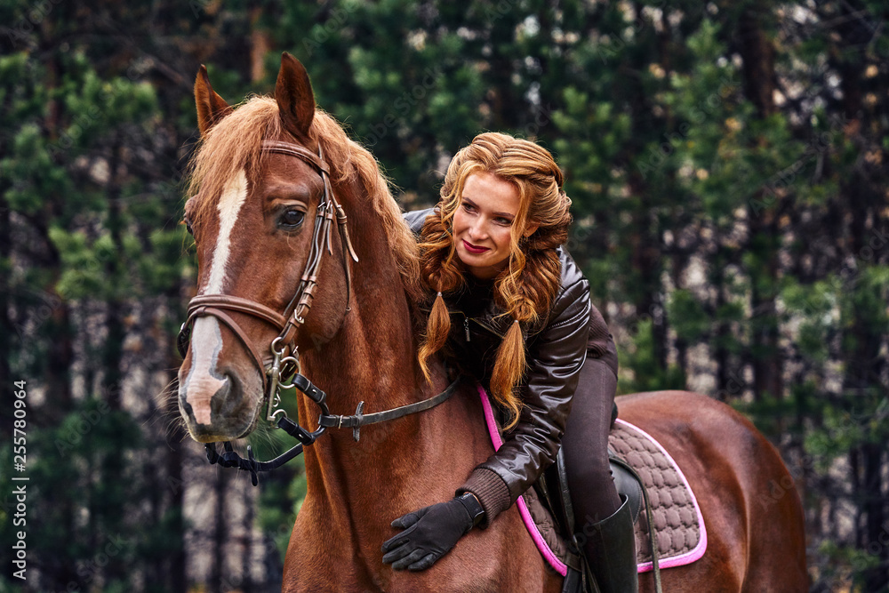 Portrait of a young beautiful woman with long brown hair. Woman on a horse walk in the forest. Portrait of a young beautiful woman with long brown hair. Woman on a horse walk in the forest.