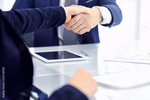 Group of business people or lawyers shaking hands finishing up a meeting , close-up. Success at negotiation and handshake concepts