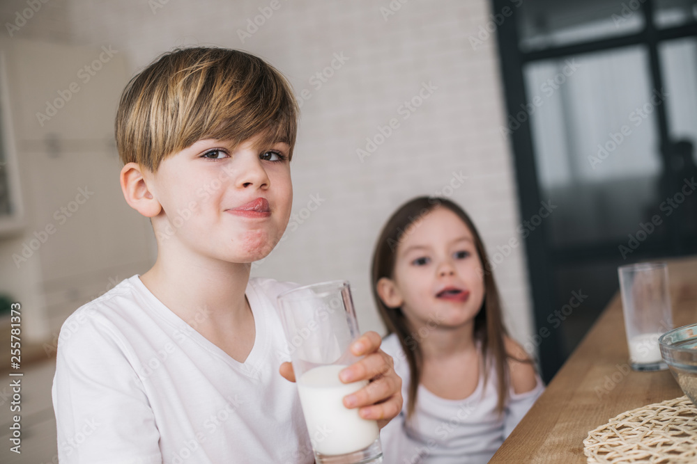 Low angle of happy children licking their mouthes at home Low angle of happy children licking their mouthes at home