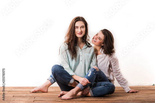 Same sex young happy couple at white background