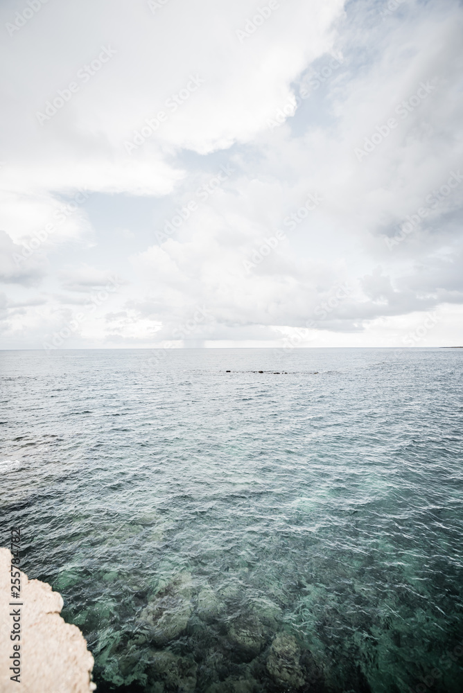 Fototapeta premium Dramatic view of the horizon on a rainy day from the tourist port of Ortigia in Syracuse.