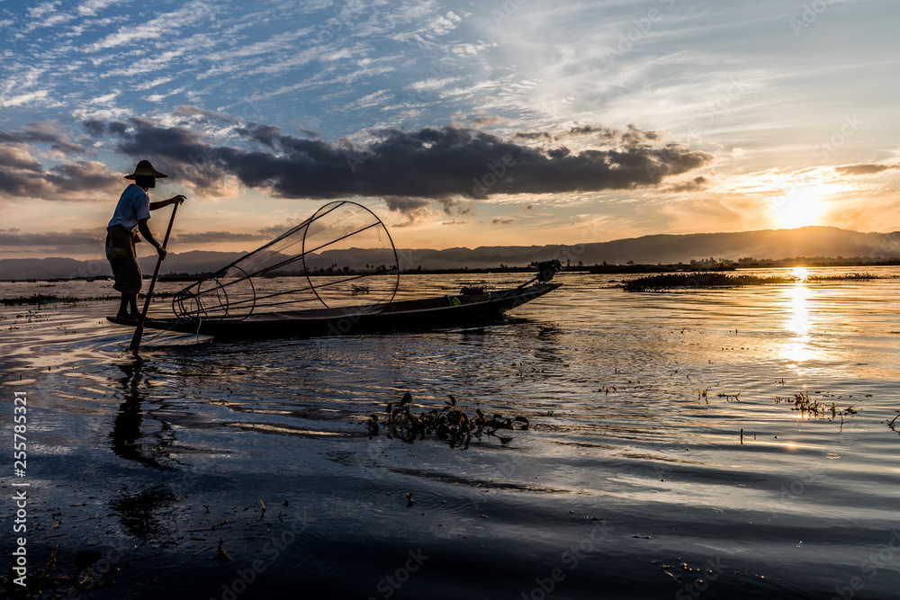 Traditional Burmese fisherman at Inle lake, Myanmar famous for their distinctive one legged rowing style