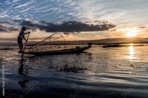 Traditional Burmese fisherman at Inle lake, Myanmar famous for their distinctive one legged rowing style