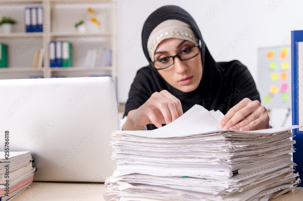 Female employee in hijab working in the office Female employee in hijab working in the office