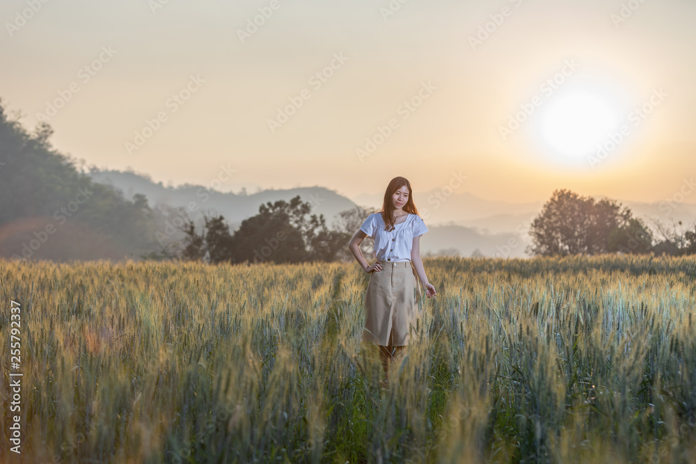 Beautiful asian woman having fun at barley field in summer at sunset time Beautiful asian woman having fun at barley field in summer at sunset time