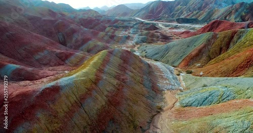 Aerial rainbow mountain landscape in 4k. Drone footage showing the most beautiful valley in Zhangye National Geopark, with sandstone hills covered by colorful pattern. Zhangye Danxia, Gansu, China.