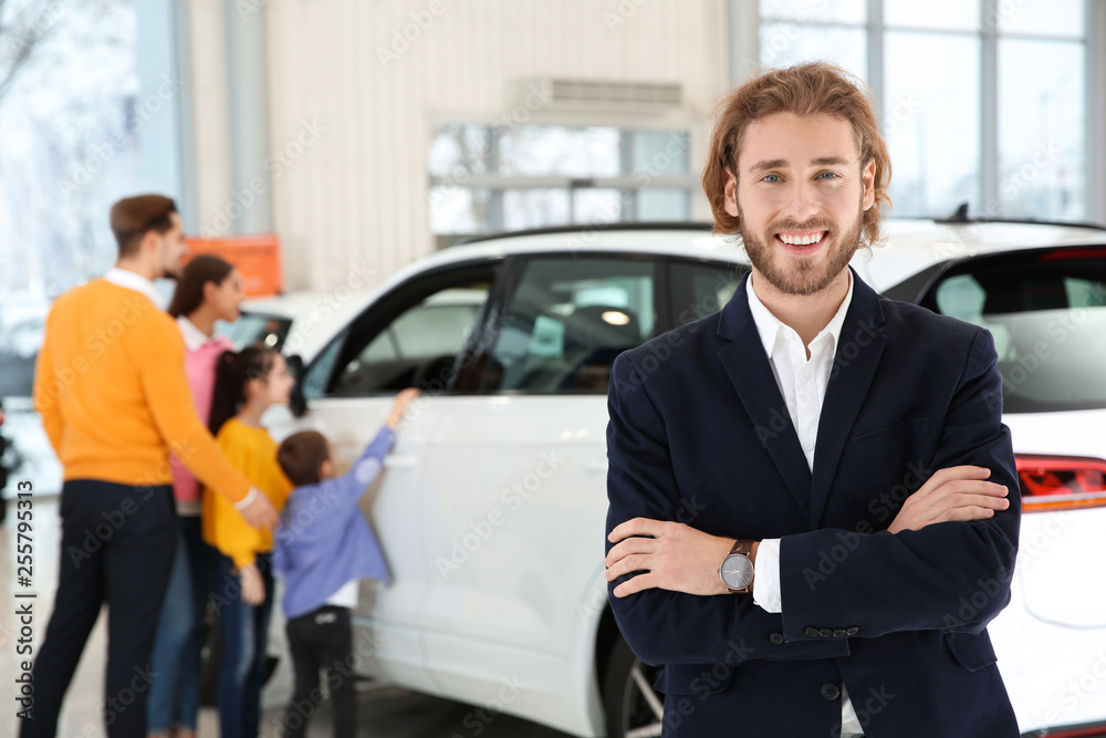 Car salesman and blurred family near auto on background Car salesman and blurred family near auto on background
