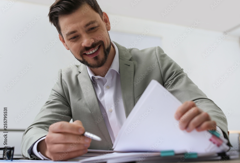 Businessman working with documents at table in office Businessman working with documents at table in office