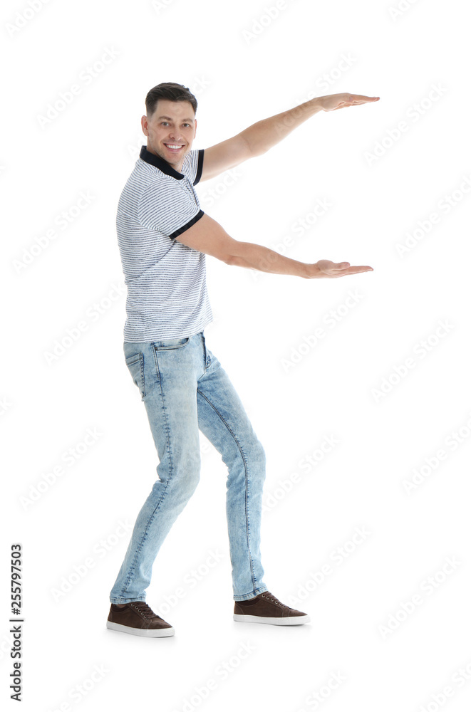 Man in casual clothes holding something on white background Man in casual clothes holding something on white background