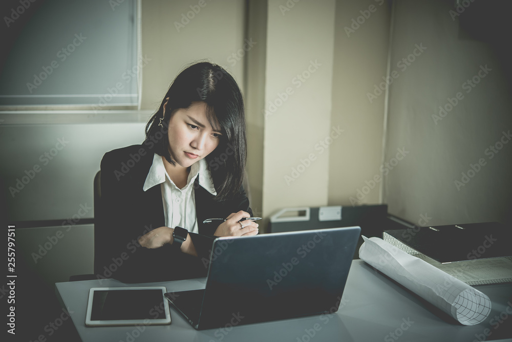 Asian woman working in office,young business woman stressed from work overload with a lot file on the desk,Thailand people thinking something Asian woman working in office,young business woman stressed from work overload with a lot file on the desk,Thailand people thinking something