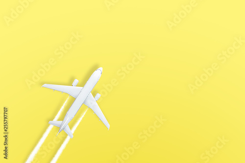 Yellow pastel paper airplane on background. Minimal concept.