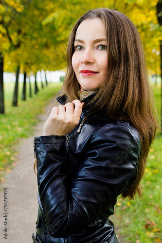 Beautiful young brunette girl. Portrait in the autumn park. Close-up