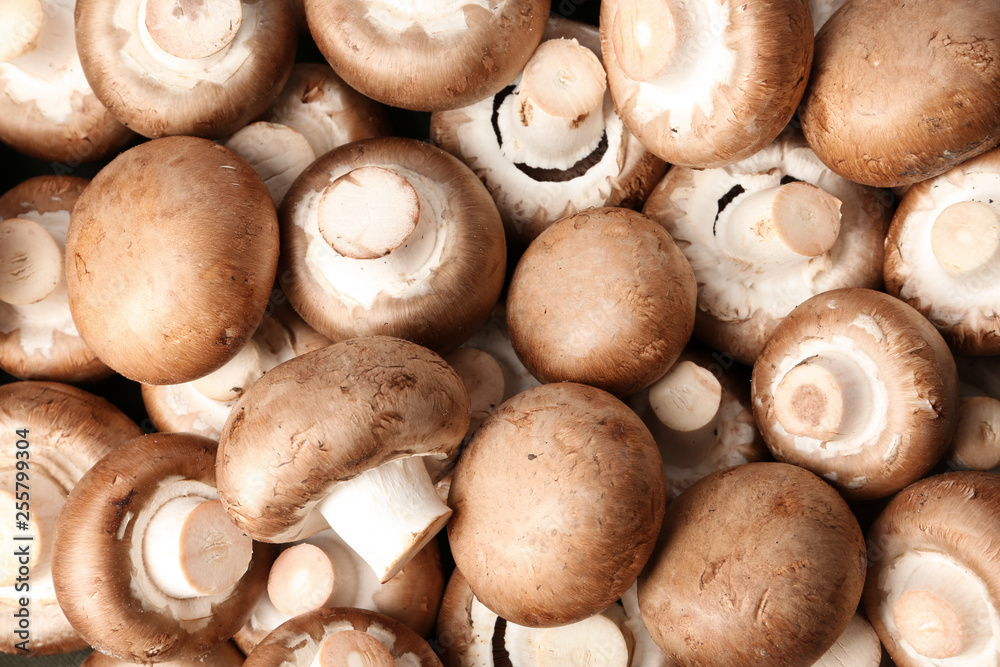 Fresh champignon mushrooms as background, top view