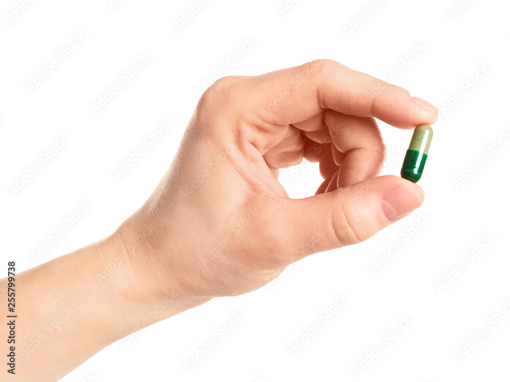 Woman holding spirulina pill on white background, closeup Woman holding spirulina pill on white background, closeup