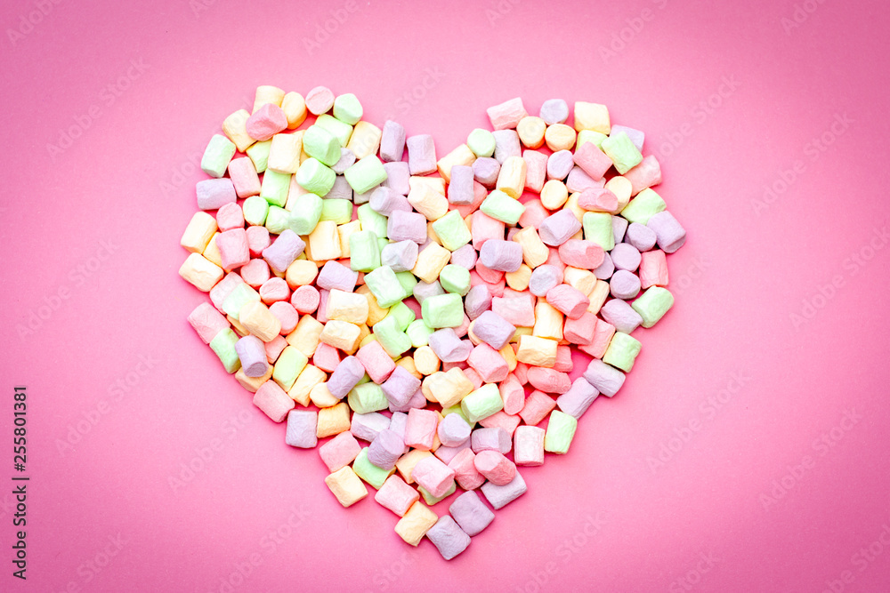 Air delicious romantic heart of tender multi-colored marshmallow on a pink background Air delicious romantic heart of tender multi-colored marshmallow on a pink background