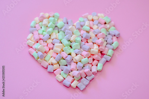 Air delicious romantic heart of tender multi-colored marshmallow on a pink background © leksann