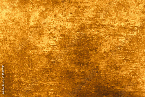 Texture natural plaster gold color. Background wall is natural concrete and stone. Rectangular size photo.