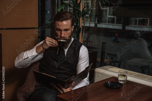 Bearded businessman with workbook