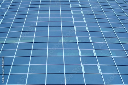Wallpaper Mural New office building in business center. Wall made of steel and glass with blue sky.  Torontodigital.ca