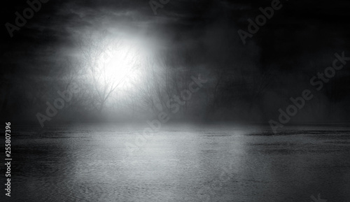 Background scene of empty street. Night view of the river  night sky with clouds  silhouettes of trees  light reflected on water. Smoke fog