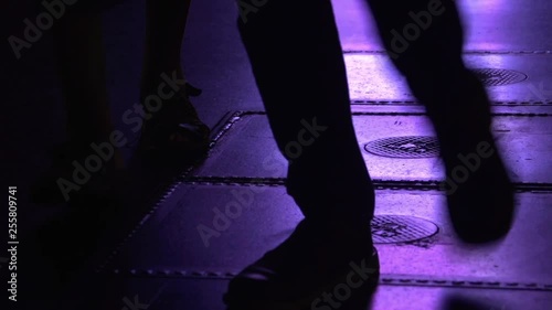 Neon City Lights On Pavement with People Walking