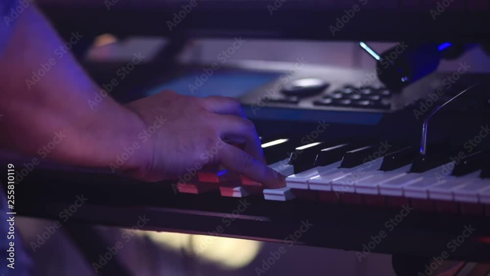hands of a man playing an electronic piano hands of a man playing an electronic piano