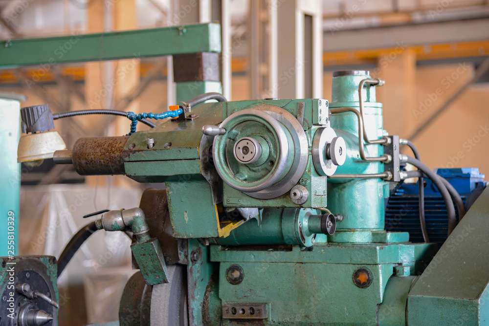 Grinding machine at a machine-building enterprise in a metalworking workshop. Grinding machine at a machine-building enterprise in a metalworking workshop.