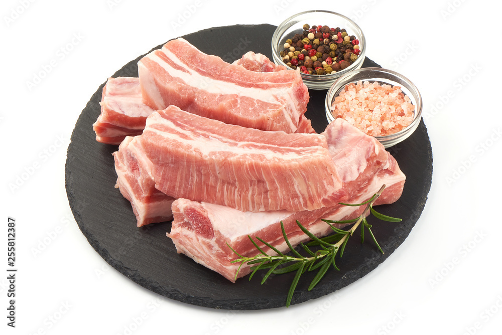 Fresh raw lamb meat ribs with rosemary and spices, close-up, isolated on white background