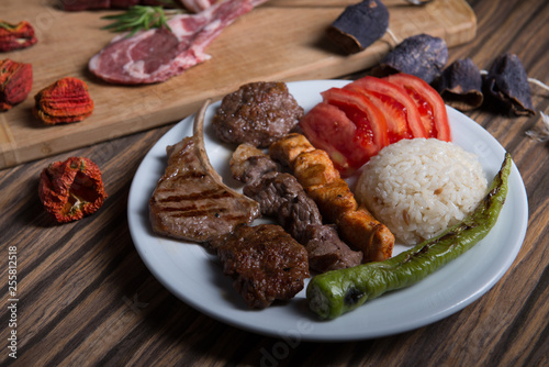 Grilled Meat plate, Turkish food served with rice tomatoes and grilled green pepper