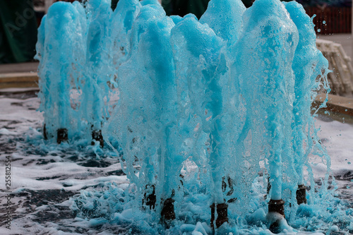 foreground in horizontal view of a source expelling blue water