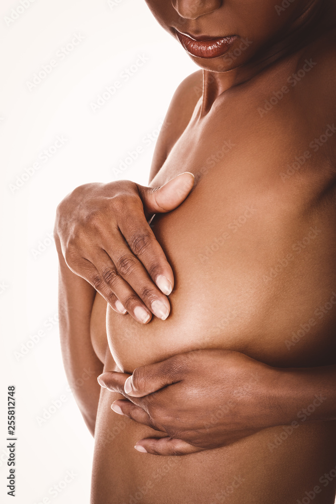 Fototapeta premium Mixed race woman doing breast self-exam (BSE). Checking up breast.